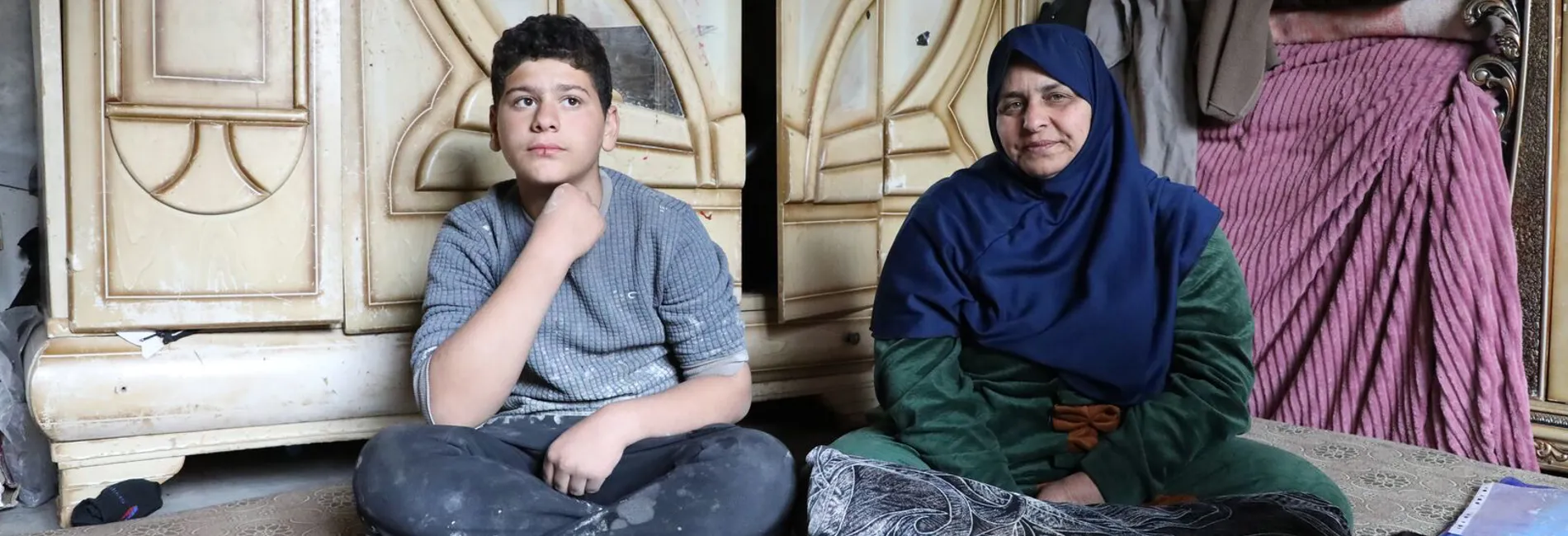 Syria_Ibtihal-and-her-youngest-son-Omar-in-their-damaged-home